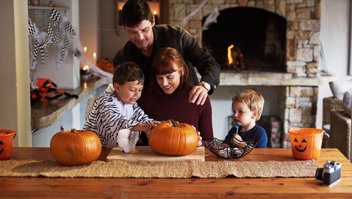 Family carving pumpkins together for Halloween