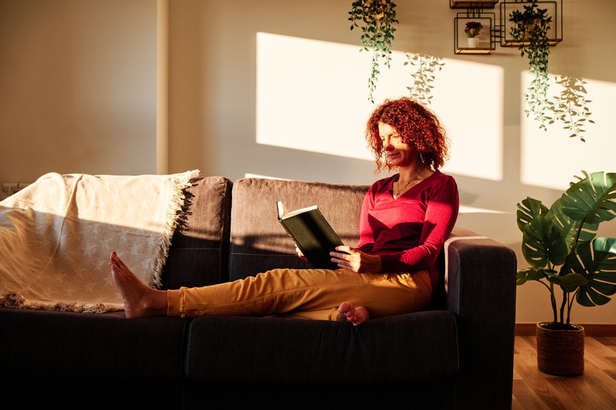 Woman in a cosy jumper enjoying a quiet autumn evening